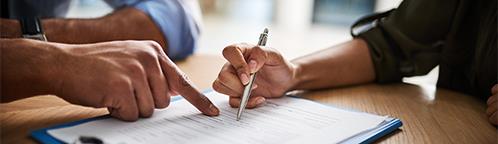 two people discussing and writing down on a paper