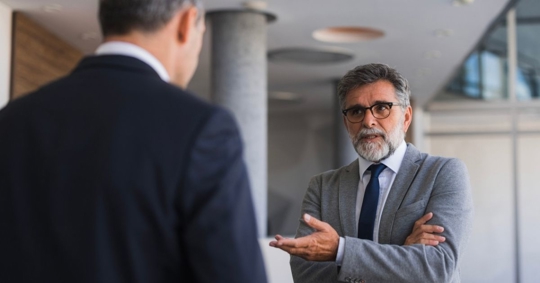 businessmen having conflict during conversation